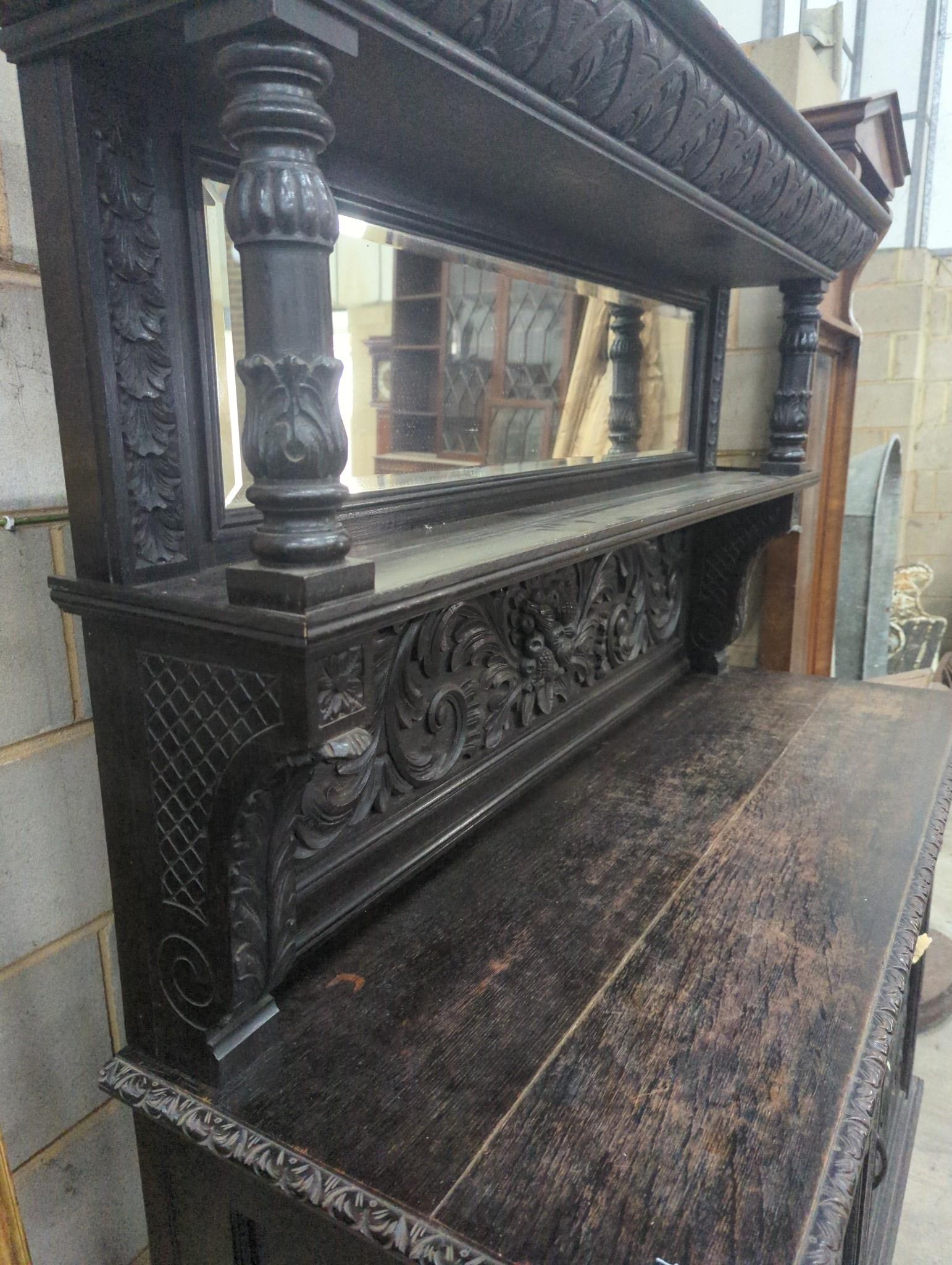 A late 19th century Flemish carved oak mirror back sideboard, width 150cm depth 56cm height 188cm